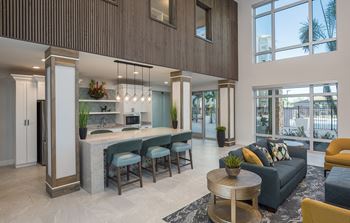 Resident lounge with kitchen, dining space and fireplace